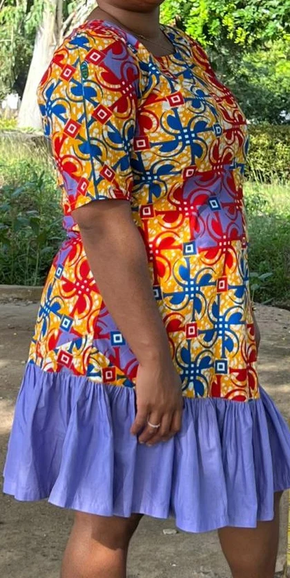 Before. Torso photographs of a client, cropped below the chin: in a red, blue and yellow patterned dress outdoors, and in a white button-front shirt dress outdoors.
